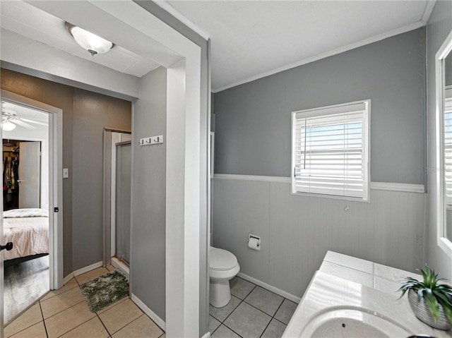 803 7th St NE, Fort Meade, FL 33841 - ensuite bathroom with tile patterned floors, a wainscoted wall, toilet, ceiling fan, and vanity