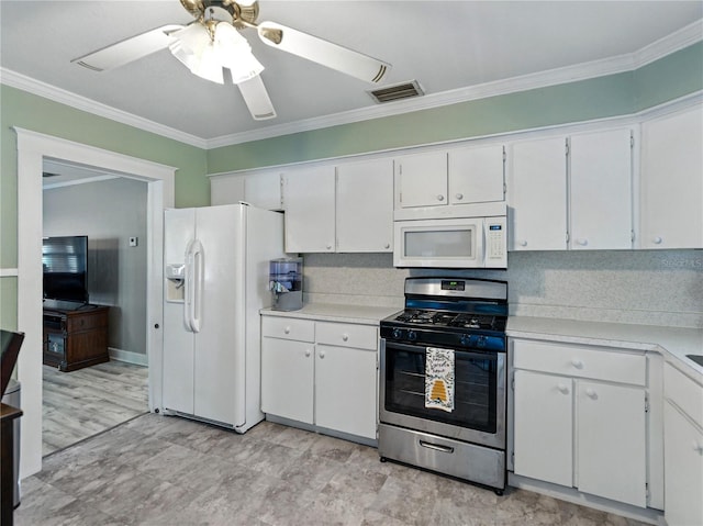 803 7th St NE, Fort Meade, FL 33841 - kitchen with white appliances, crown molding, a ceiling fan, light countertops, and white cabinets