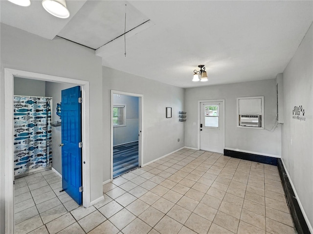 803 7th St NE, Fort Meade, FL 33841 - foyer entrance with light tile patterned floors, baseboards, and cooling unit