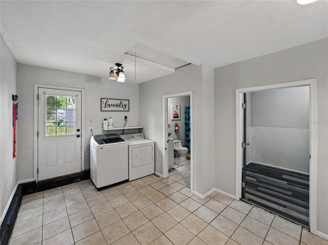 803 7th St NE, Fort Meade, FL 33841 - washroom featuring washer and dryer, light tile patterned flooring, and baseboards