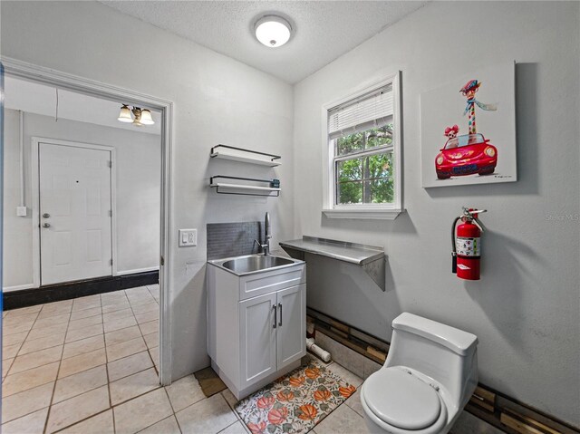803 7th St NE, Fort Meade, FL 33841 - bathroom with toilet, vanity, a textured ceiling, and tile patterned flooring