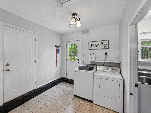 803 7th St NE, Fort Meade, FL 33841 - washroom featuring washing machine and clothes dryer, light tile patterned flooring, and baseboards