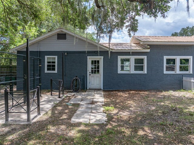 803 7th St NE, Fort Meade, FL 33841 - back of house featuring a patio area, metal roof, and stucco siding