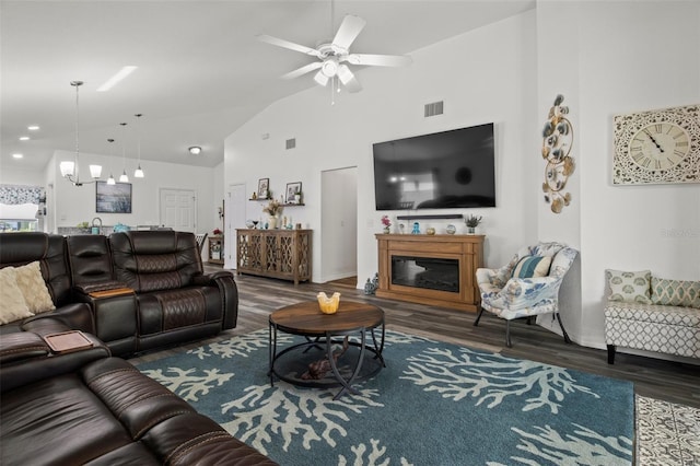 living area featuring high vaulted ceiling, ceiling fan, wood finished floors, and visible vents