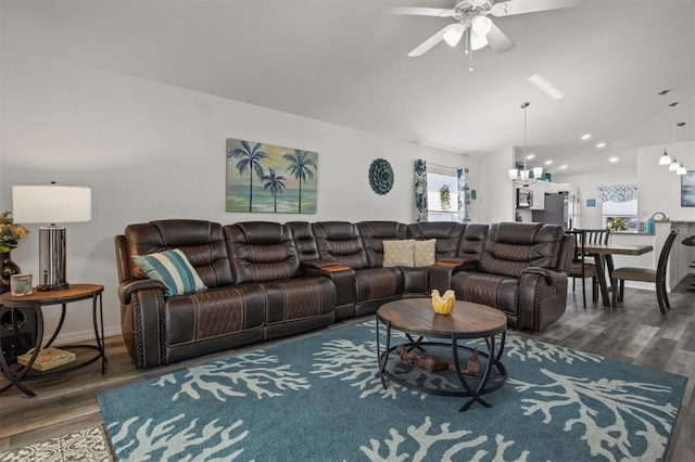 living area with ceiling fan with notable chandelier, lofted ceiling, and wood finished floors