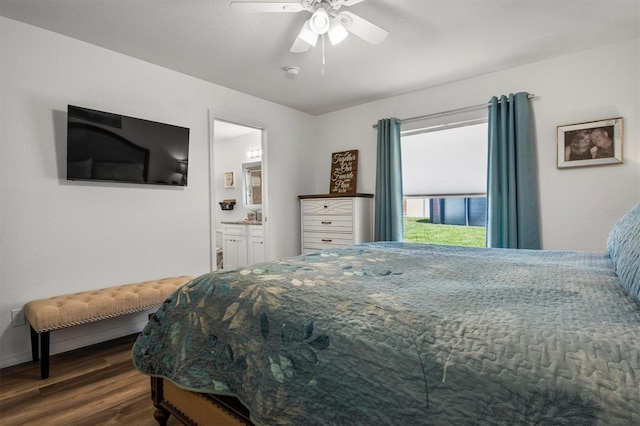 bedroom featuring dark wood-style flooring, baseboards, ceiling fan, and ensuite bathroom
