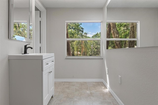 6317 Discovery Ln, Land O Lakes, FL 34638 - laundry room featuring baseboards, a sink, and a healthy amount of sunlight