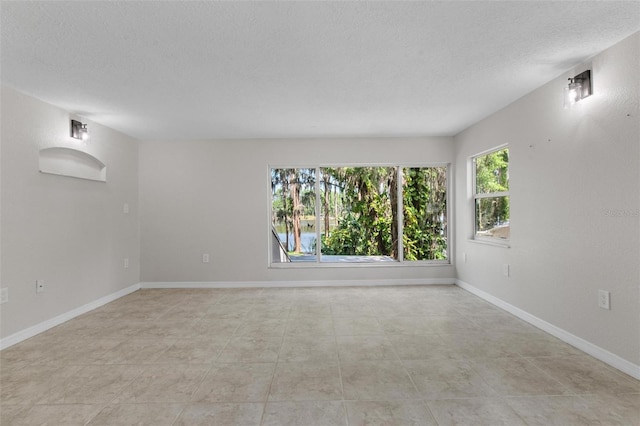 6317 Discovery Ln, Land O Lakes, FL 34638 - unfurnished room featuring baseboards and a textured ceiling