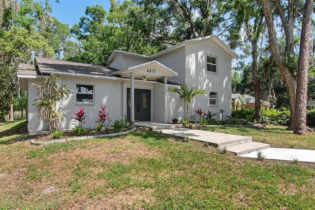 6317 Discovery Ln, Land O Lakes, FL 34638 - view of front facade featuring stucco siding and a front lawn