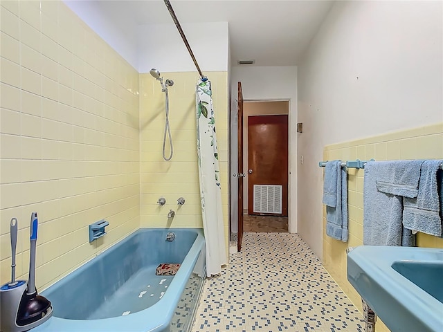full bath with tile patterned floors, shower / bathtub combination with curtain, and visible vents