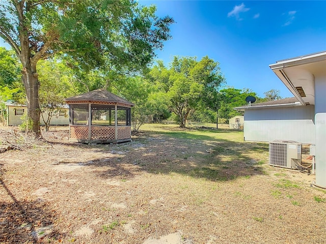 view of yard featuring central air condition unit and a gazebo