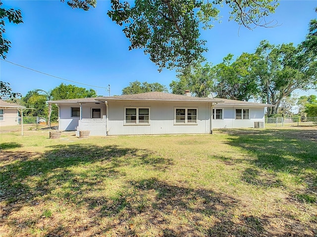 back of house with a yard and fence