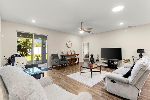living room with a ceiling fan, baseboards, recessed lighting, wood finished floors, and visible vents