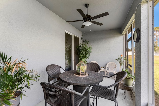 sunroom / solarium featuring a ceiling fan and outdoor dining space