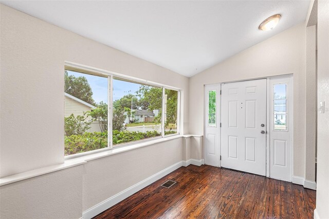 entrance foyer with baseboards, lofted ceiling, dark wood finished floors, and visible vents