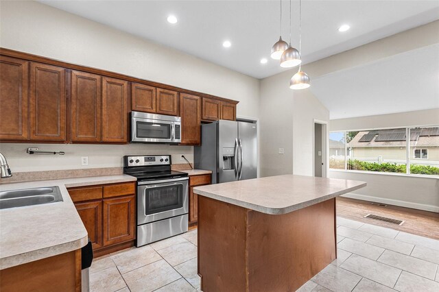 kitchen with visible vents, light countertops, a sink, appliances with stainless steel finishes, and light tile patterned floors