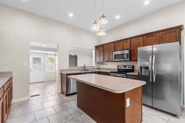 kitchen with a sink, light countertops, a center island, stainless steel appliances, and recessed lighting