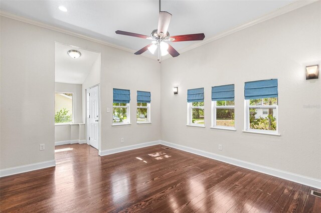 unfurnished room with crown molding, ceiling fan, baseboards, wood finished floors, and visible vents