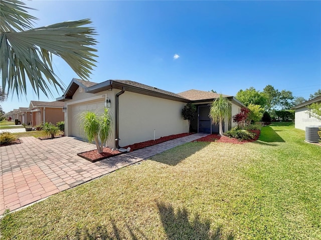 4480 Turnberry Ln, Lake Wales, FL 33859 - single story home featuring a garage, a front yard, decorative driveway, stucco siding, and central AC unit