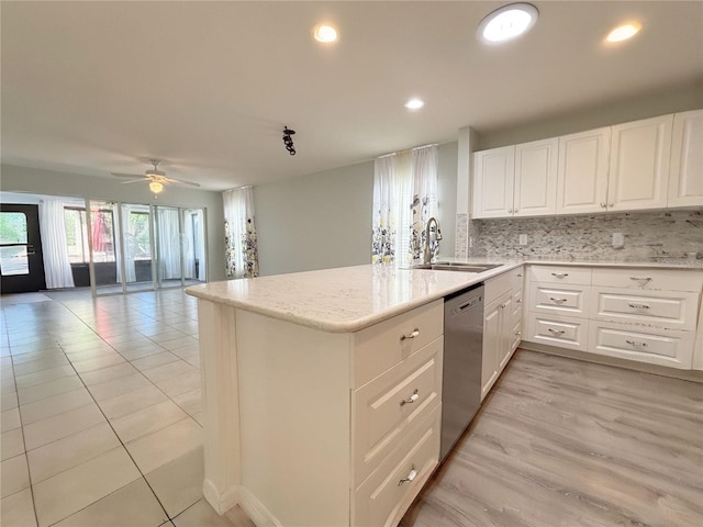 4480 Turnberry Ln, Lake Wales, FL 33859 - kitchen with ceiling fan, light stone counters, a sink, white cabinetry, and stainless steel dishwasher