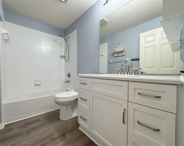 4480 Turnberry Ln, Lake Wales, FL 33859 - bathroom with shower / bath combination, wood finished floors, vanity, toilet, and a textured wall