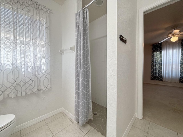 4480 Turnberry Ln, Lake Wales, FL 33859 - full bathroom with tile patterned floors, ceiling fan, toilet, and tiled shower