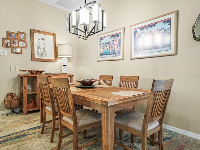 dining room featuring baseboards and a notable chandelier
