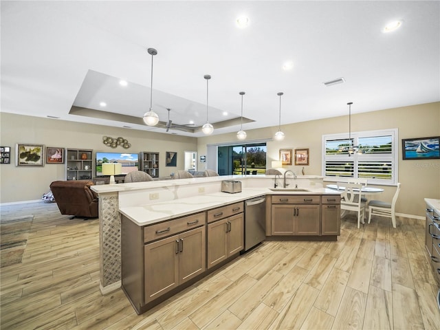 kitchen featuring dishwasher, light wood-type flooring, open floor plan, and visible vents