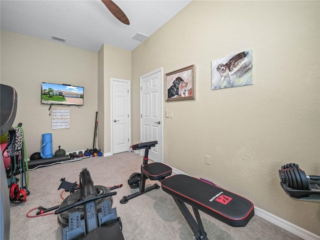 exercise area with carpet floors, a ceiling fan, baseboards, and visible vents