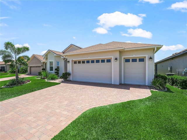 ranch-style home with decorative driveway, a front lawn, and stucco siding