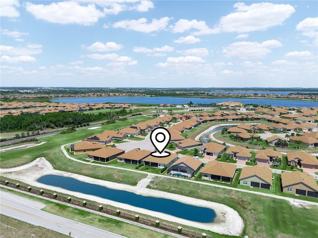 drone / aerial view featuring a water view and a residential view