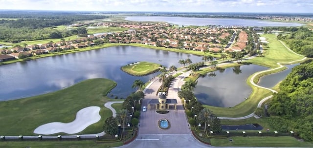 drone / aerial view with a residential view, a water view, and golf course view