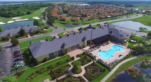 drone / aerial view with a water view and a residential view