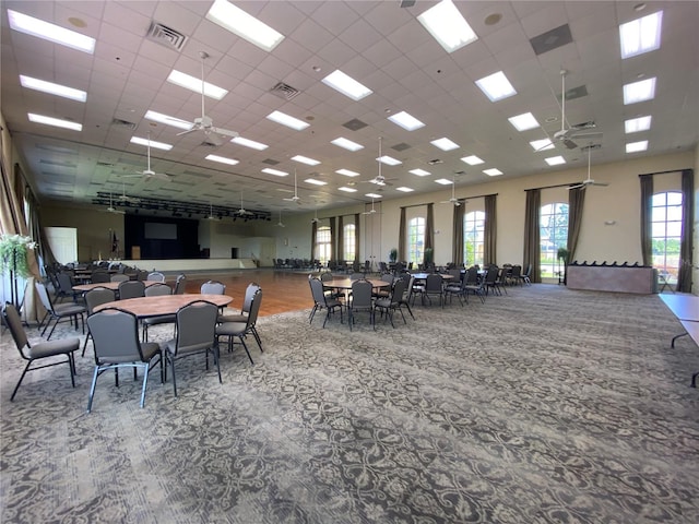 carpeted dining area featuring a ceiling fan and visible vents