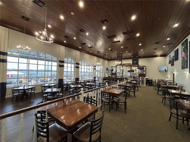 dining room featuring visible vents, wood ceiling, and a notable chandelier