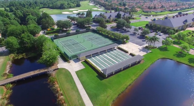 birds eye view of property with a water view and golf course view