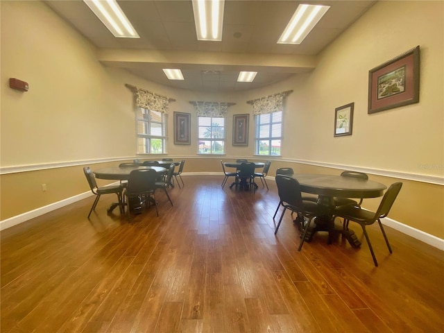 dining area with baseboards, wood finished floors, and a wealth of natural light