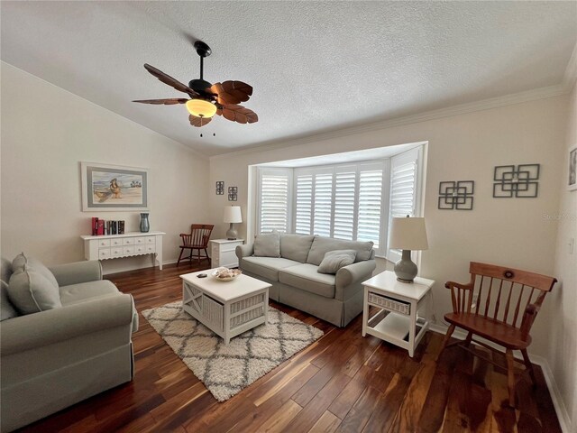 living room featuring a ceiling fan, dark wood finished floors, ornamental molding, and lofted ceiling