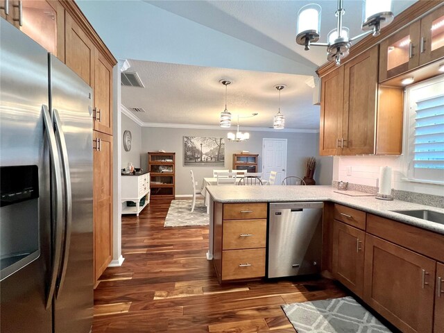 kitchen with ornamental molding, stainless steel appliances, a peninsula, and a chandelier