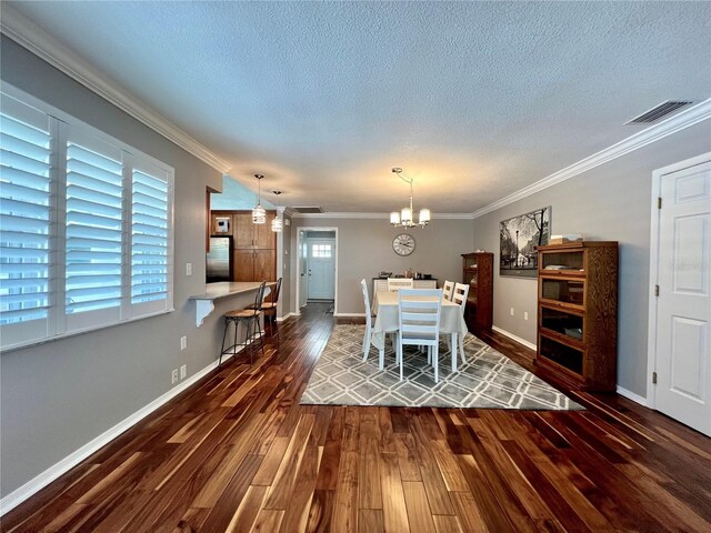dining room with a textured ceiling, a notable chandelier, and dark wood-style floors