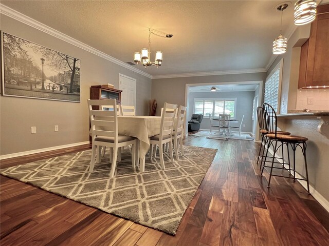dining room with crown molding, baseboards, ceiling fan with notable chandelier, and dark wood-style floors