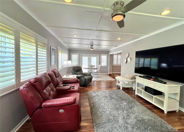 living area featuring dark wood-style flooring, a ceiling fan, and a healthy amount of sunlight
