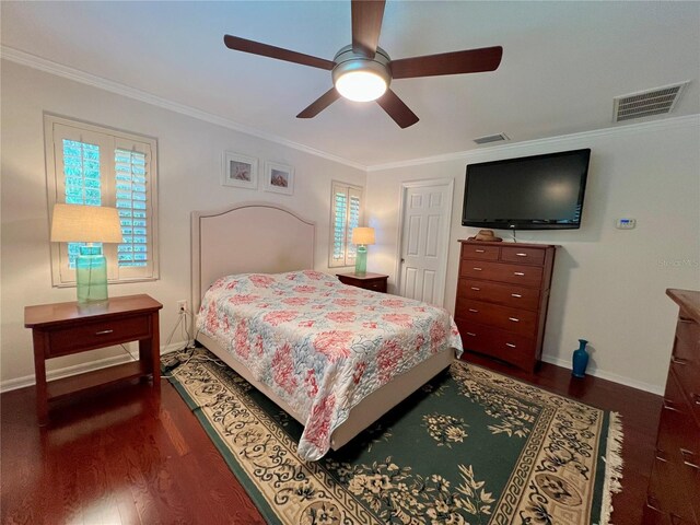 bedroom featuring visible vents, ornamental molding, baseboards, and wood finished floors