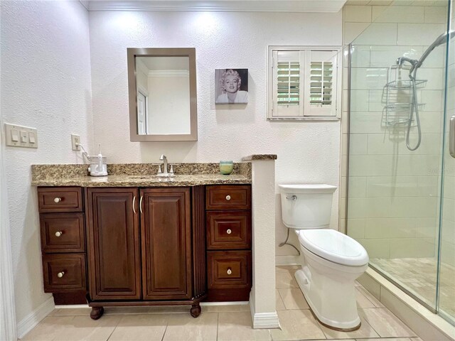 bathroom featuring vanity, tile patterned floors, a stall shower, and toilet