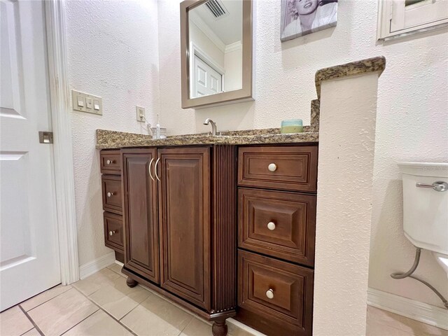 bathroom featuring vanity, ornamental molding, tile patterned floors, and visible vents