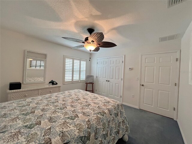 bedroom featuring baseboards, ceiling fan, dark colored carpet, and visible vents