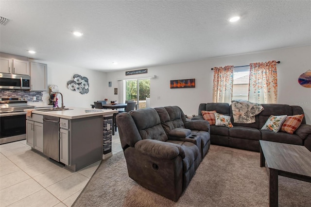 living area with recessed lighting, a textured ceiling, light tile patterned floors, and visible vents
