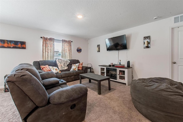 living area featuring light carpet, a textured ceiling, and visible vents