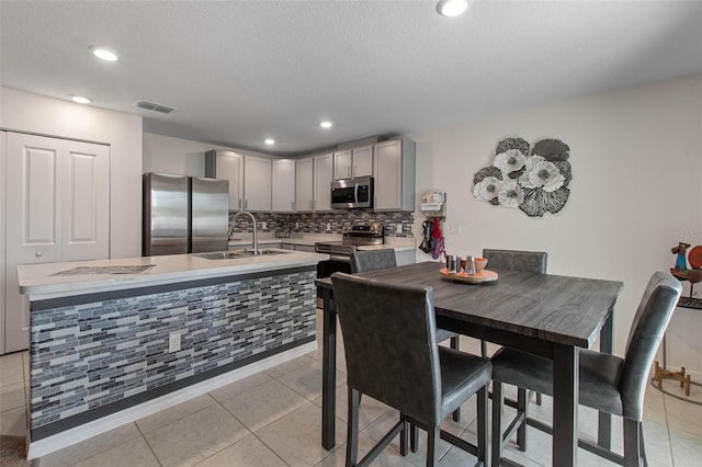 dining area featuring light tile patterned floors, recessed lighting, a textured ceiling, and visible vents