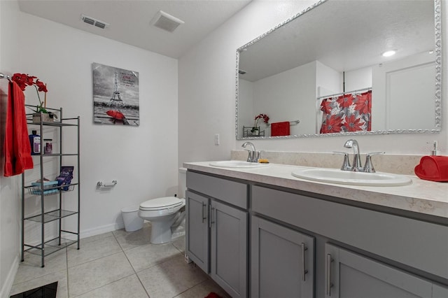 full bathroom featuring baseboards, a sink, tile patterned floors, and toilet